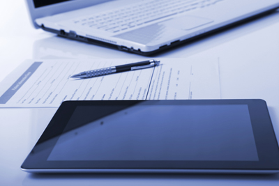 A picture of an iPad, a laptop and a pen.