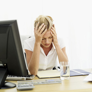 A student working on some homework with her head in her hands.