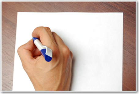 Writing a piece of paper with a pen.